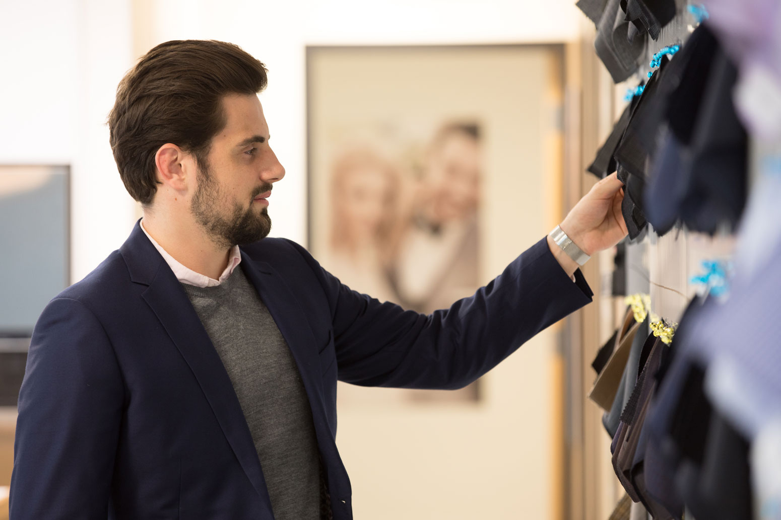 An INDOCHINO employee arranging fabric samples.