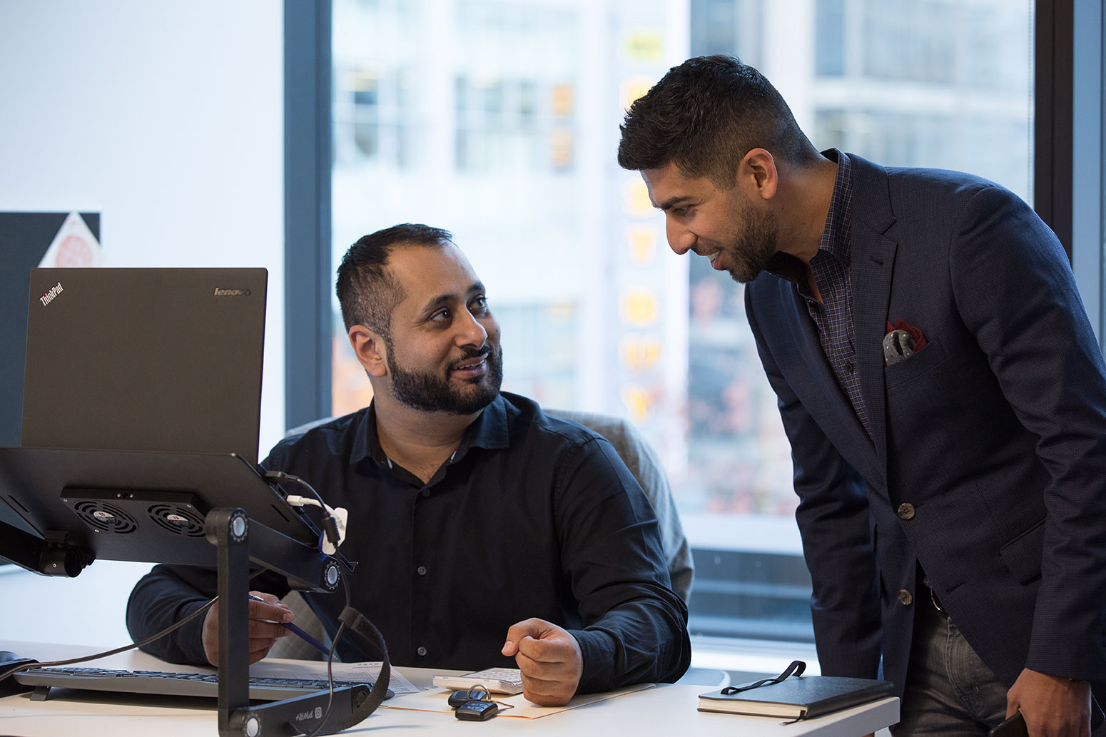 Two employees having a conversation at INDOCHINO headquarters.